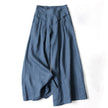FJØRNA lightweight summer trousers for women, high waist wide-leg style with side pockets, shown in a natural fabric finish.
