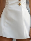 FJØRNA gold satin sheath dress with high collar, elegant design, and smooth silky fabric, perfect for formal occasions.