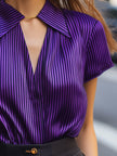 Purple satin blouse for women by FJØRNA featuring striped pattern, short sleeves, and a wide collar.