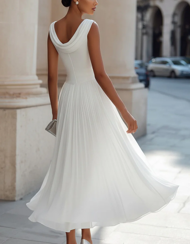 FJØRNA chiffon midi dress for women with draped neckline and pleated design, showcasing a flowing, elegant style.