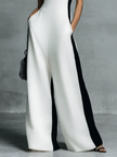FJØRNA black and white cotton-linen women’s jumpsuit with deep V-neck, wide-leg pants, and spaghetti straps, casual summer style.
