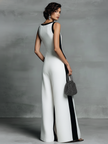 Black and white cotton-linen jumpsuit for women with deep V-neck, wide-leg design, and spaghetti straps by FJØRNA.