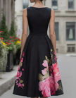 FJØRNA black midi dress for women with floral print, sleeveless design and fitted silhouette, shown on a model.