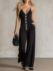 Black colour-block V-neck sleeveless jumpsuit by FJØRNA with button-down front and relaxed fit, shown on a model.