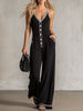 Black colour-block V-neck sleeveless jumpsuit by FJØRNA with button-down front and relaxed fit, shown on a model.