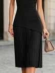 FJØRNA elegant sleeveless asymmetrical pleated midi dress with round neckline, showcasing flowing fabric and stylish design.