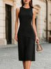 FJØRNA elegant sleeveless asymmetrical pleated midi dress with round neckline, flowing fabric and stylish design.