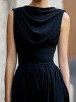 FJØRNA elegant sleeveless maxi dress with draped design and waist definition, suitable for formal occasions.