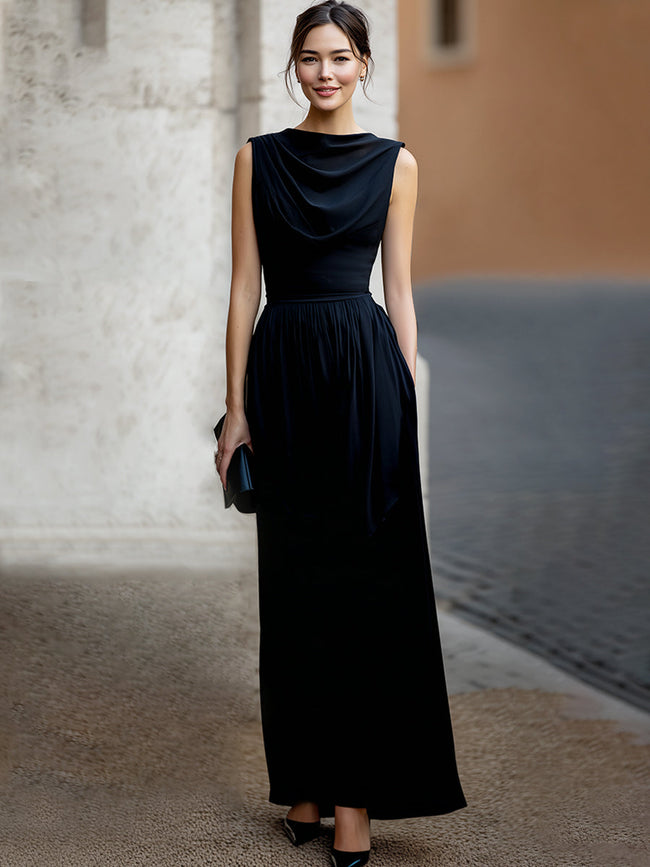 FJØRNA elegant sleeveless maxi dress with draped waist and flowing fabric, perfect for formal occasions.
