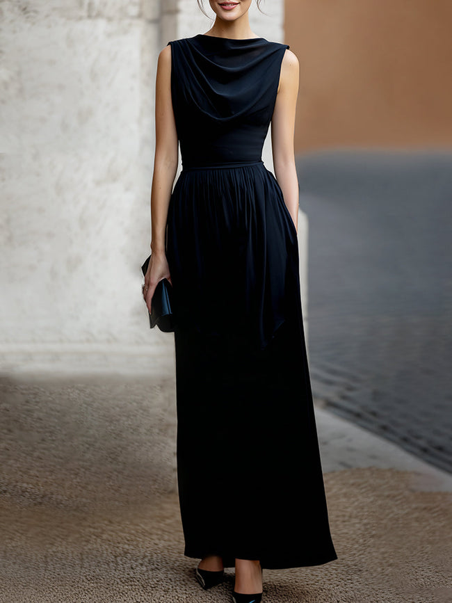 FJØRNA elegant sleeveless maxi dress with draped design and waist definition, showcasing a flowing, sophisticated style.