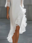 FJØRNA asymmetric ruffle hem sheer sleeve midi dress displayed on a model, featuring elegant ruffles and flowing sheer fabric.