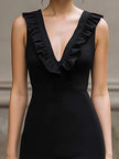 FJØRNA ruffled deep V-neck sleeveless bodycon midi dress, form-fitting with ruffle details and a sleek design.