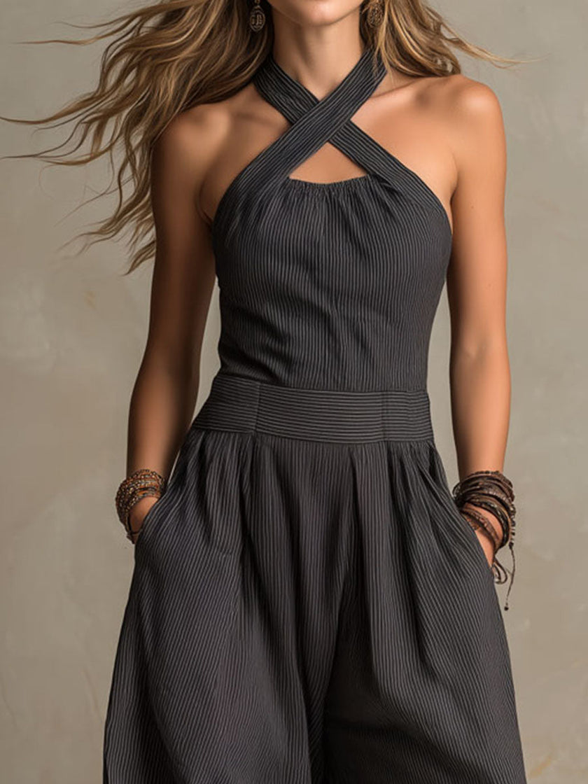 Charcoal pinstripe halter neck wide-leg jumpsuit for women by FJØRNA, featuring a stylish halter neckline and flowing wide-leg design.