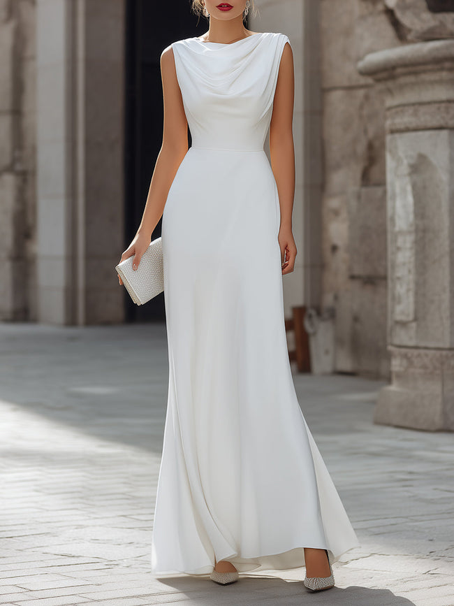 FJØRNA sleeveless draped cowl neck A-line maxi dress with flowing fabric and elegant silhouette, displayed on a hanger.