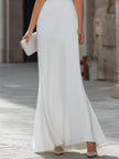 FJØRNA sleeveless draped cowl neck A-line maxi dress with flowing fabric and elegant silhouette, displayed on a hanger.