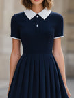Navy blue contrast collar polo neck pleated flared A-line mini dress by FJØRNA showing front view with pleated skirt and collar detail.