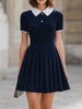 Navy blue contrast collar polo neck pleated flared A-line mini dress by FJØRNA, featuring a fitted bodice and pleated skirt.