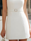 FJØRNA white sleeveless mini dress with sheer mesh, pearl embellishments, yoke detail, and belt for a chic, fitted look.