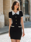 FJØRNA black contrast collar button-front bodycon mini dress, close-up showing fitted silhouette and stylish collar detail.