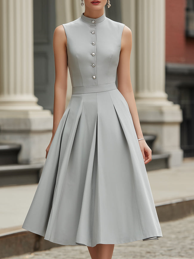 FJØRNA high neck button-front pleated A-line midi dress hanging on a white background, showcasing its elegant design and pleated details.