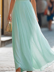 FJØRNA halter neck pleated flowing maxi dress with elegant design and soft fabric, perfect for summer or formal occasions.