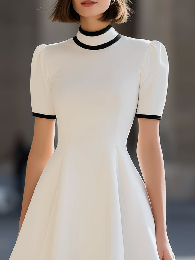 White contrast trim high neck short sleeve flared A-line mini dress by FJØRNA, featuring a stylish high neckline and flared hem.