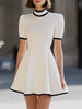 FJØRNA white high neck short sleeve flared A-line mini dress with contrast trim, stylish and elegant for casual or formal wear.