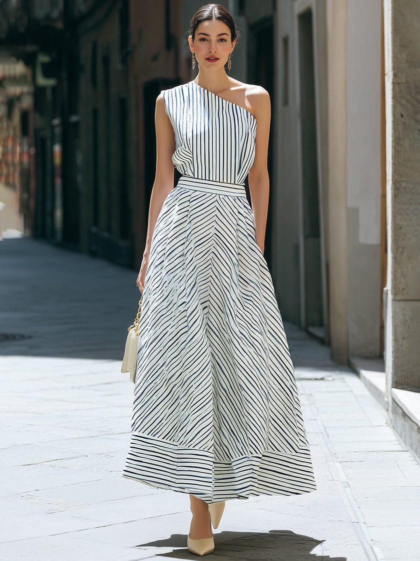 FJØRNA one-shoulder striped pleated midi dress featuring a stylish silhouette and elegant design, perfect for a sophisticated look.