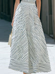 FJØRNA one-shoulder striped pleated midi dress displayed on a hanger, featuring bold vertical stripes and elegant pleats.