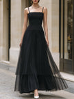 Elegant black tiered tulle maxi dress by FJØRNA, featuring flowing layers and a sophisticated silhouette.
