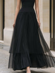 Elegant black tiered tulle maxi dress by FJØRNA, featuring flowing layers and a sophisticated design, suitable for formal occasions.
