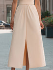Beige sleeveless midi dress with lapel collar by FJØRNA, elegant design perfect for formal occasions.