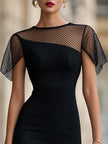 FJØRNA sheer mesh panel fitted midi dress showing a close-up of the dress's see-through mesh details and sleek fit.