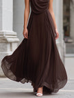Elegant brown chiffon maxi dress by FJØRNA with draped cowl neck and sleeveless design, flowing and sophisticated for formal occasions.