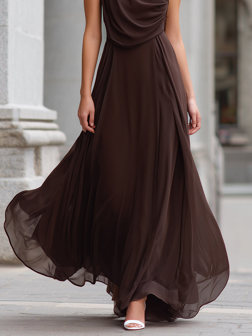 Elegant brown chiffon maxi dress by FJØRNA with draped cowl neck and sleeveless design, flowing and sophisticated for formal occasions.