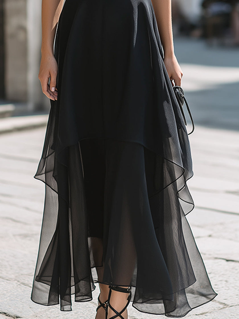 FJØRNA halter neck layered chiffon maxi dress with flowing fabric and tiered design, perfect for elegant occasions.