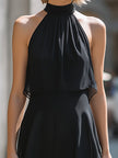 FJØRNA halter neck layered chiffon maxi dress displayed on a hanger, featuring flowing fabric and elegant design.