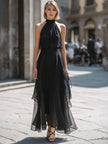 FJØRNA halter neck layered chiffon maxi dress showcased on a model, featuring flowing fabric and elegant design.