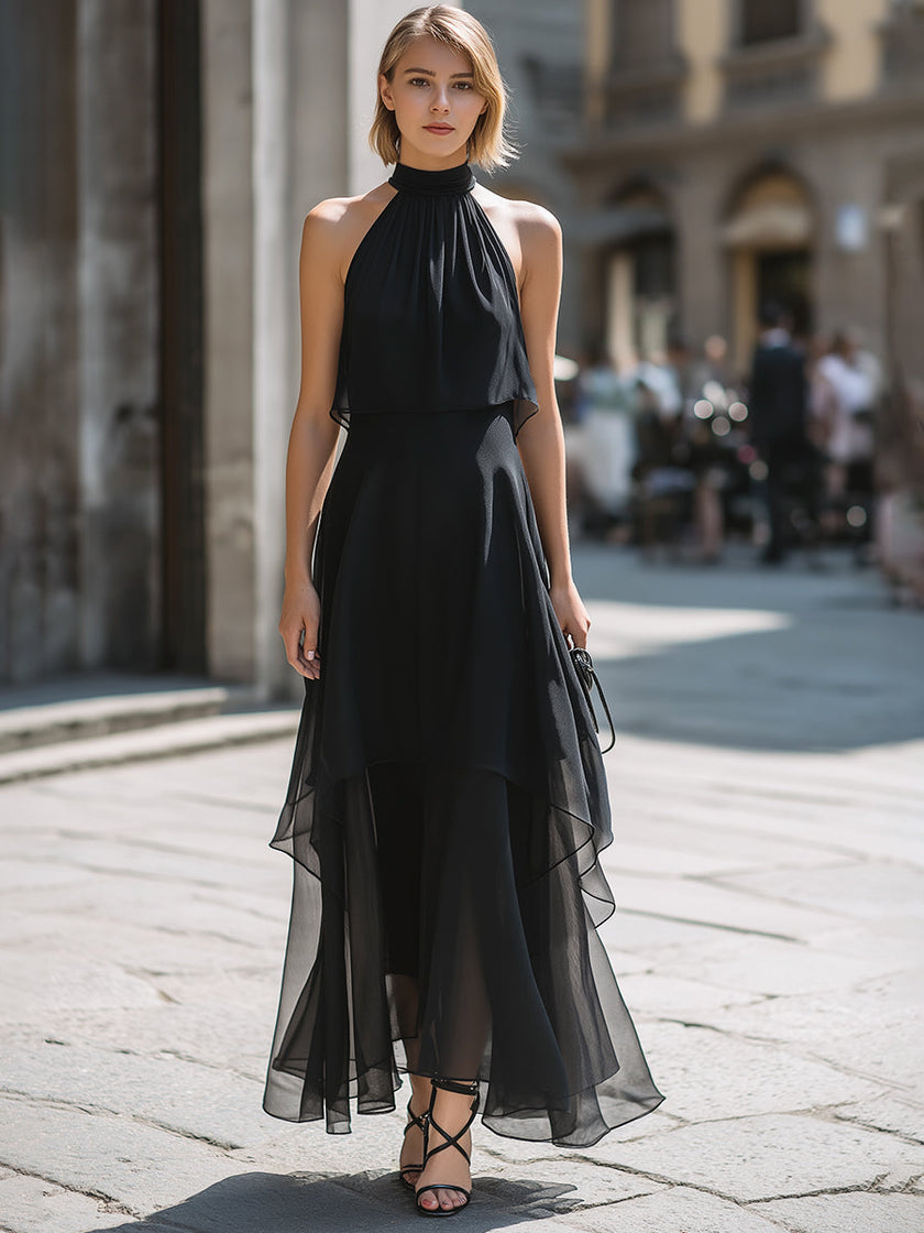 FJØRNA halter neck layered chiffon maxi dress showcased on a model, featuring flowing fabric and elegant design.