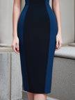 FJØRNA colorblock panel sleeveless midi dress with structured fit and short sleeves, featuring bold color blocking and a sleek silhouette.