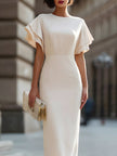 FJØRNA minimalist halter neck column midi dress hanging on a rack, showcasing sleek, elegant design and smooth fabric.