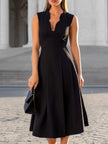 Black scalloped edge V-neck sleeveless fit-and-flare midi dress by FJØRNA, shown with a flowing silhouette and scalloped hem detail.
