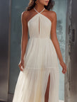 FJØRNA halter neck maxi dress with pleated flowing fabric, elegant and lightweight for summer or special occasions.
