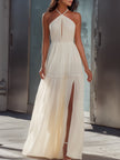 FJØRNA halter neck pleated flowing maxi dress in soft fabric, featuring a sleeveless design and elegant draping.