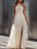 FJØRNA halter neck pleated flowing maxi dress in soft fabric, featuring a sleeveless design and elegant draping.