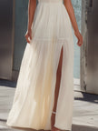 FJØRNA halter neck pleated flowing maxi dress with a lightweight, elegant design and a gathered waist, perfect for formal occasions.