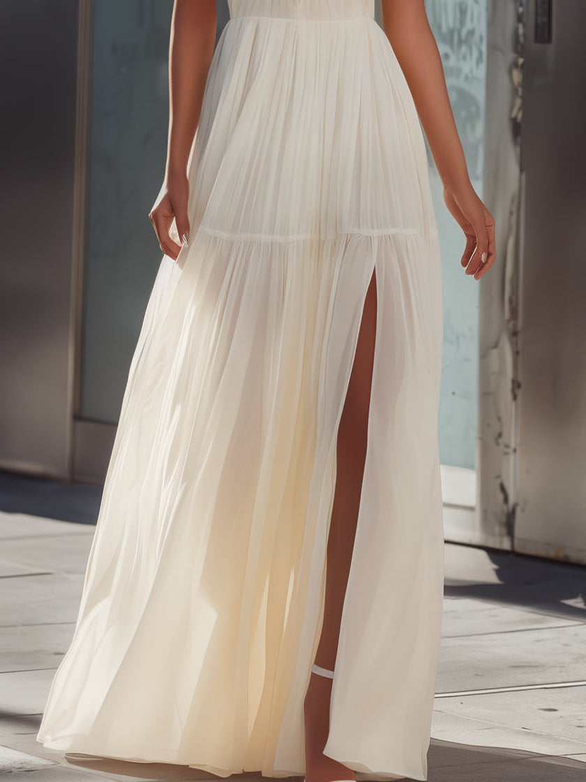 FJØRNA halter neck pleated flowing maxi dress with a lightweight, elegant design and a gathered waist, perfect for formal occasions.