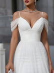 FJØRNA off-shoulder sheer overlay pleated maxi dress displayed on a hanger with flowing fabric and elegant design.