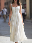 FJØRNA square-neck sleeveless button-front gathered midi dress displayed on a model.
