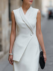 FJØRNA asymmetric wrap panel tailored midi dress displayed on a model, featuring a stylish, modern design with a fitted waist and elegant silhouette.